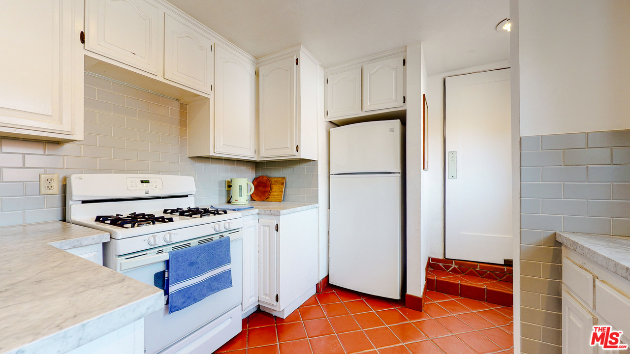 6854 Iris Circle Los Angeles, CA 90068 - Photo 9 of 35 a kitchen with stainless steel appliances a refrigerator stove and sink