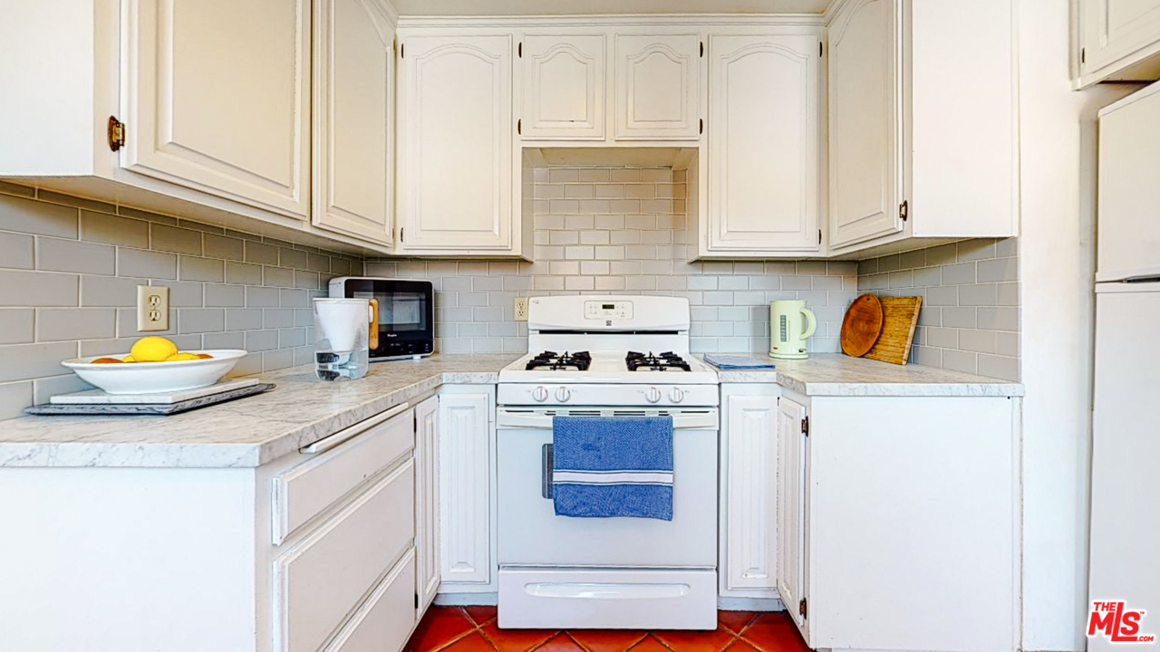6854 Iris Circle Los Angeles, CA 90068 - Photo 10 of 35 a kitchen with stainless steel appliances granite countertop a sink and cabinets