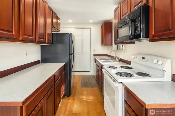 a hallway with a sink and cabinets
