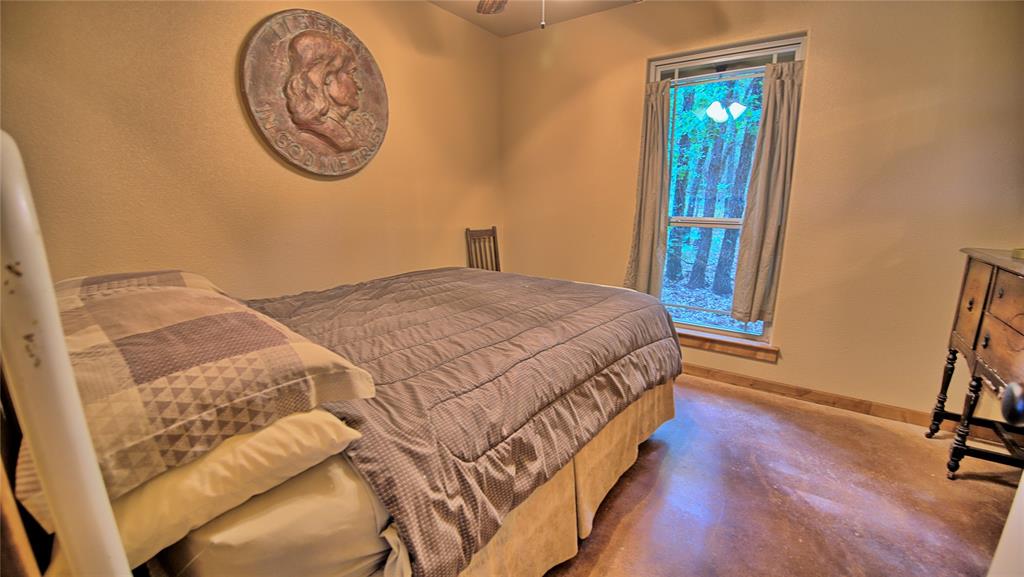 4509 Lazy E Road St. Jo, TX 76265 - Photo 27 of 39 a bedroom with a bed and a window
