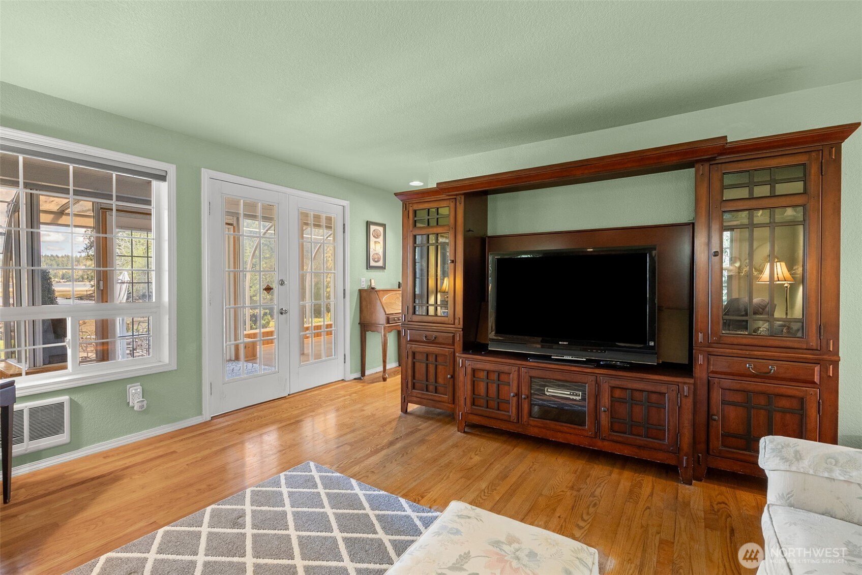 8320 East Grapeview Loop Road Allyn, WA 98524 - Photo 13 of 38 a living room with furniture and a flat screen tv