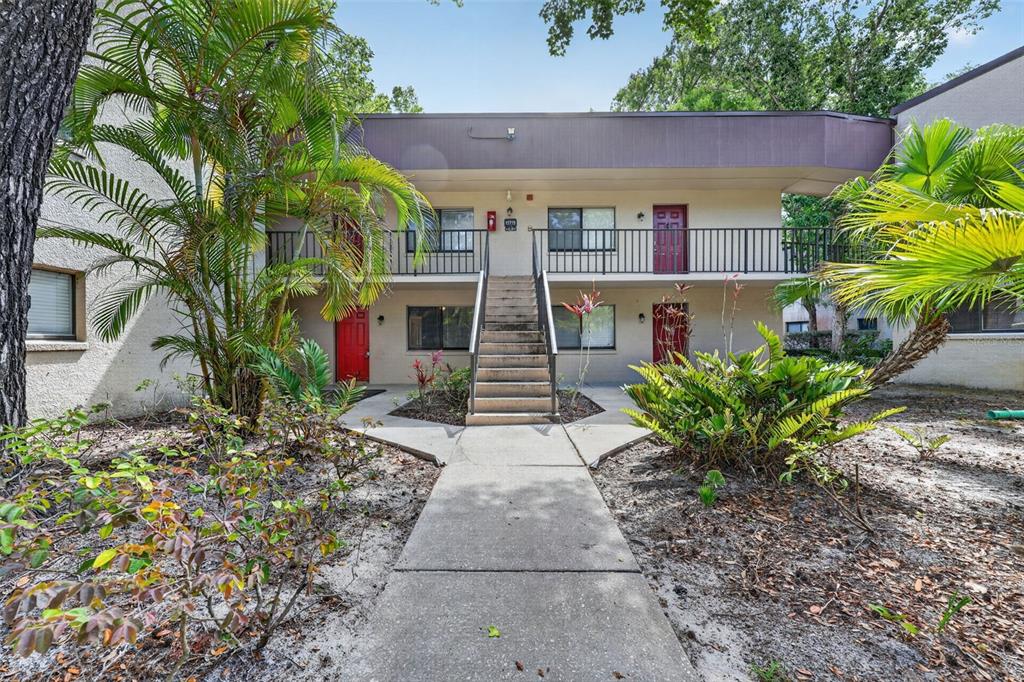 11715 Raintree Village Boulevard, Unit A Temple Terrace, FL 33617 - Photo 1 of 30 a house with lots of trees in front of it