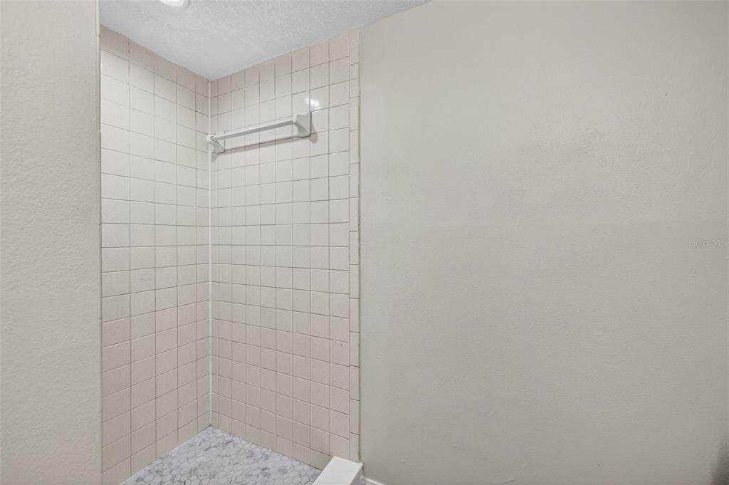 11715 Raintree Village Boulevard, Unit A Temple Terrace, FL 33617 - Photo 11 of 30 a bathroom with a shower