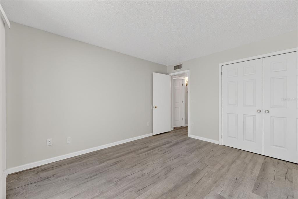 11715 Raintree Village Boulevard, Unit A Temple Terrace, FL 33617 - Photo 14 of 30 a view of an empty room and wooden floor