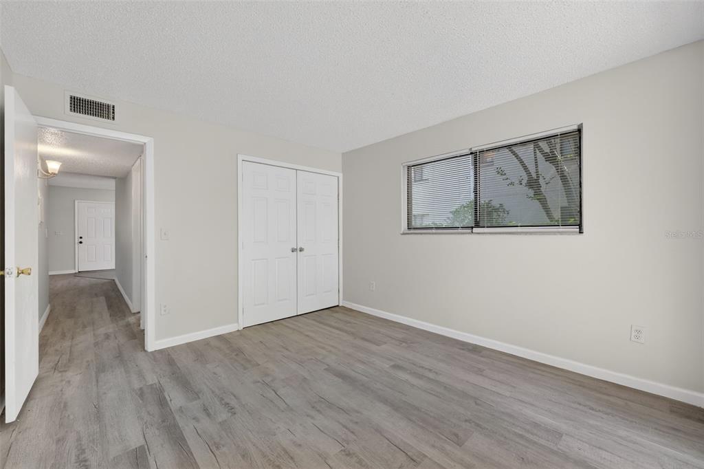 11715 Raintree Village Boulevard, Unit A Temple Terrace, FL 33617 - Photo 15 of 30 a view of an empty room with wooden floor and closet