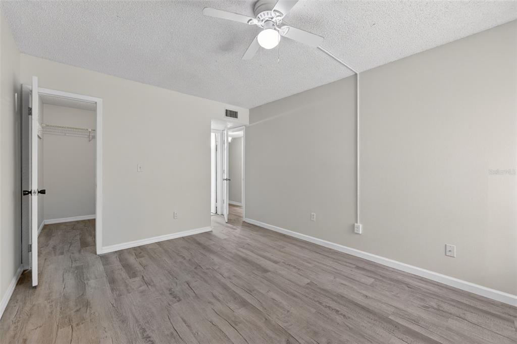 11715 Raintree Village Boulevard, Unit A Temple Terrace, FL 33617 - Photo 17 of 30 a view of an empty room with wooden floor