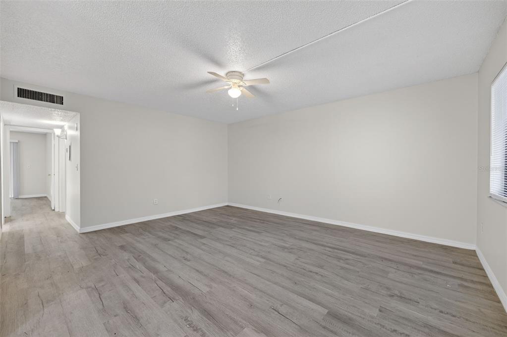 11715 Raintree Village Boulevard, Unit A Temple Terrace, FL 33617 - Photo 18 of 30 a view of an empty room with wooden floor