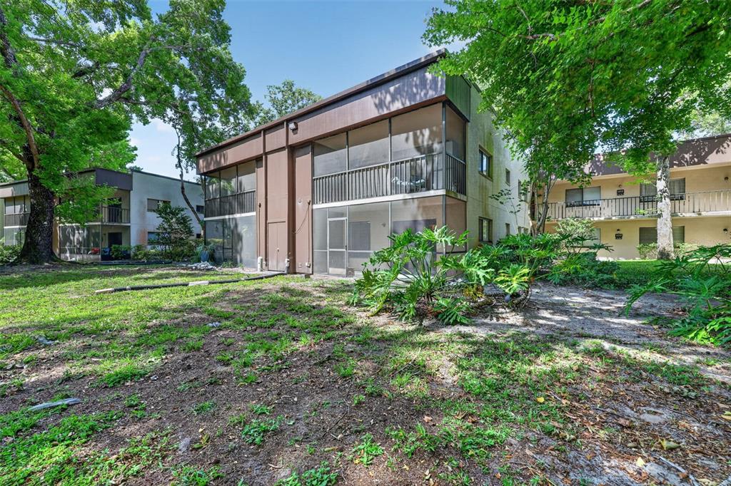 11715 Raintree Village Boulevard, Unit A Temple Terrace, FL 33617 - Photo 21 of 30 a view of a house with backyard and garden