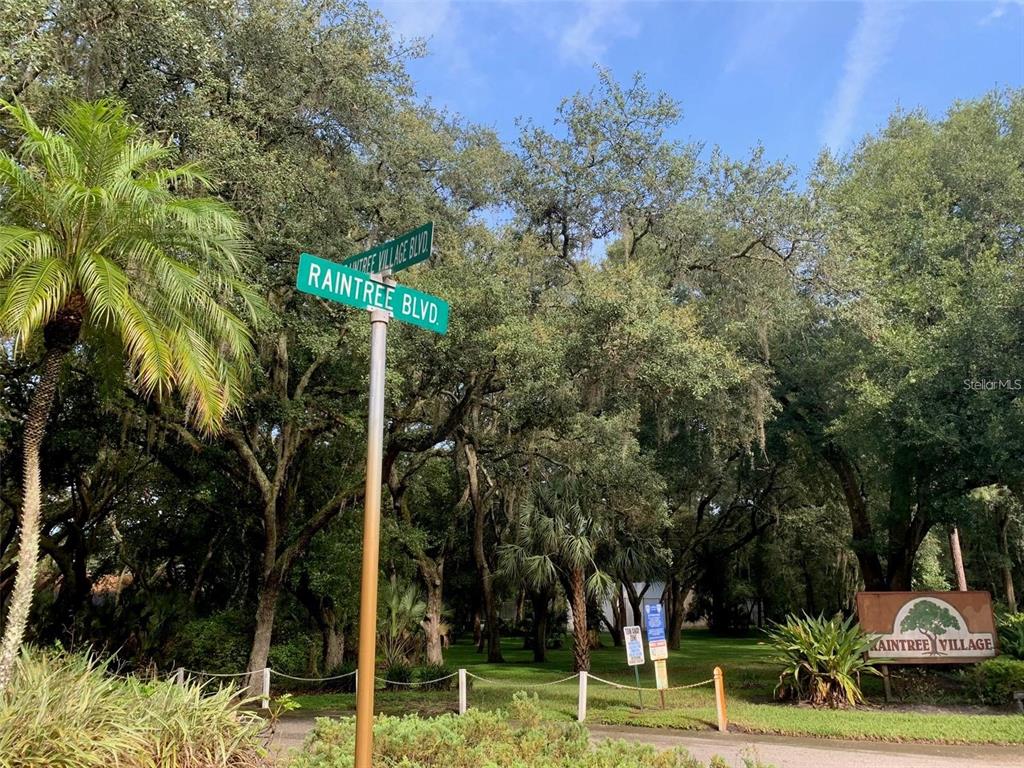 11715 Raintree Village Boulevard, Unit A Temple Terrace, FL 33617 - Photo 28 of 30 a sign that is sitting in front of a house with trees