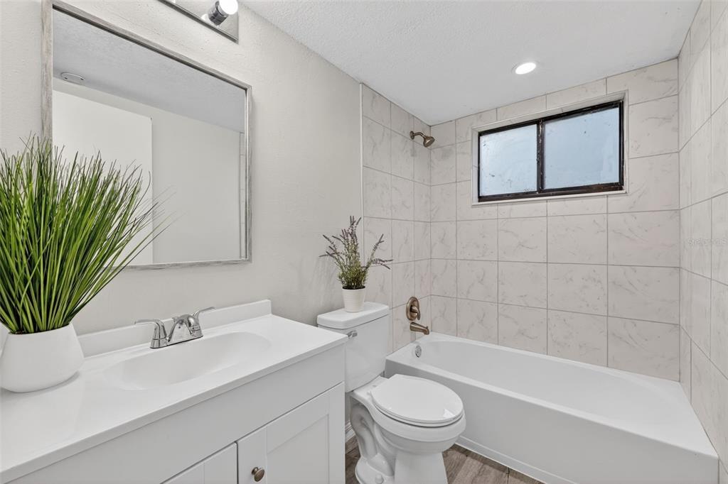 11715 Raintree Village Boulevard, Unit A Temple Terrace, FL 33617 - Photo 9 of 30 a bathroom with a sink a toilet and bathtub