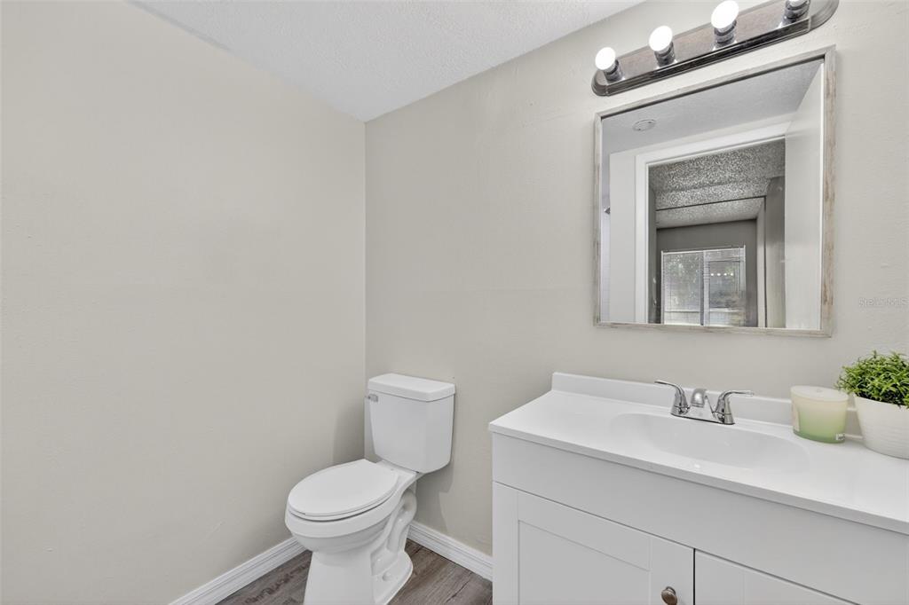11715 Raintree Village Boulevard, Unit A Temple Terrace, FL 33617 - Photo 10 of 30 a bathroom with a toilet sink and mirror