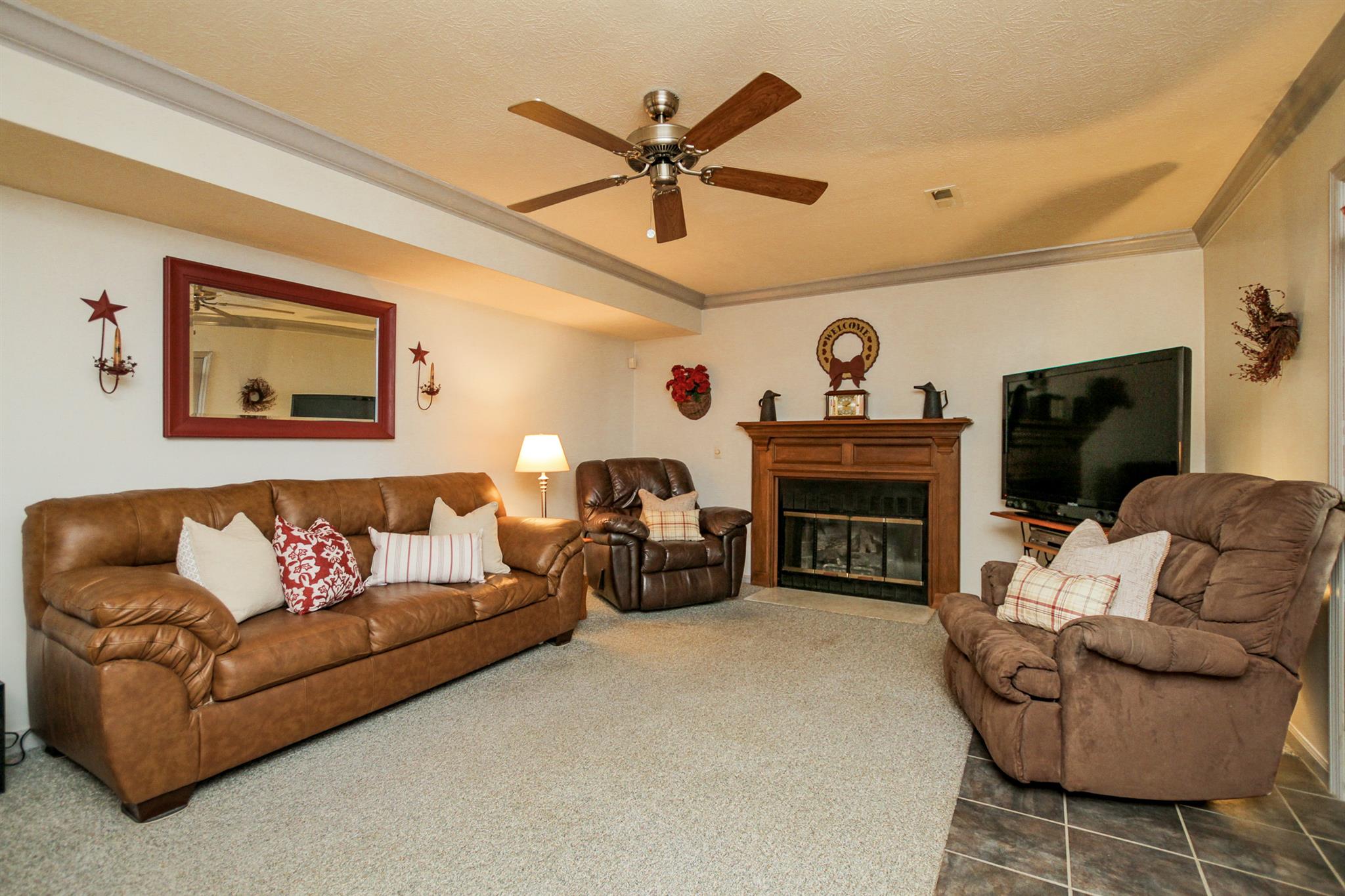 3128 Anderson Road Antioch, TN 37013 - Photo 9 of 27 a living room with furniture a fireplace and a flat screen tv
