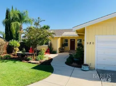 a view of a house with backyard sitting area and garden