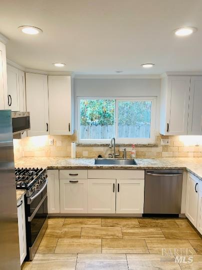 920 Linwood Street Vacaville, CA 95688 - Photo 2 of 38 a large kitchen with stainless steel appliances granite countertop a sink and cabinets