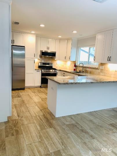920 Linwood Street Vacaville, CA 95688 - Photo 26 of 38 a kitchen with stainless steel appliances granite countertop a sink a stove a refrigerator and white cabinets