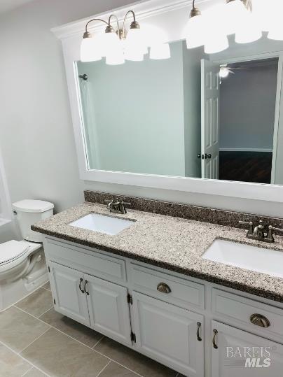 920 Linwood Street Vacaville, CA 95688 - Photo 34 of 38 a bathroom with a granite countertop sink a toilet and mirror