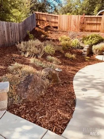 a view of a backyard with wooden fence