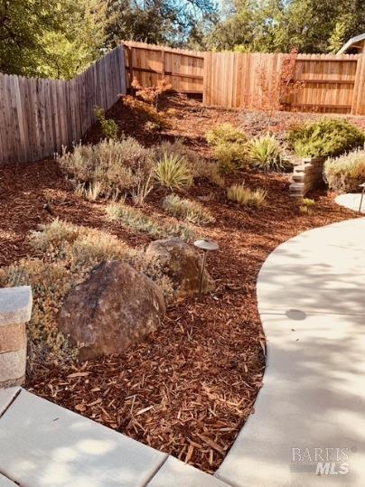 920 Linwood Street Vacaville, CA 95688 - Photo 5 of 38 a view of a backyard with wooden fence
