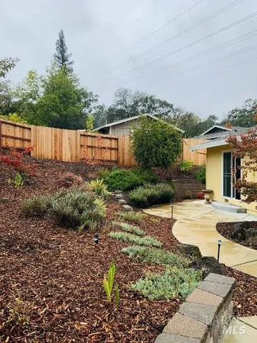 a view of a house with backyard and sitting area