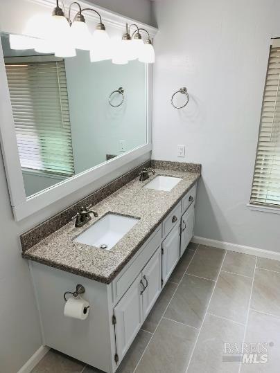920 Linwood Street Vacaville, CA 95688 - Photo 10 of 38 a bathroom with a granite countertop sink and a mirror