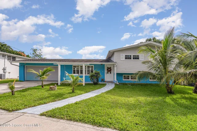 a view of a house with a yard porch and sitting area