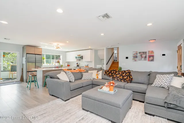 a living room with furniture or couch and a wooden floor