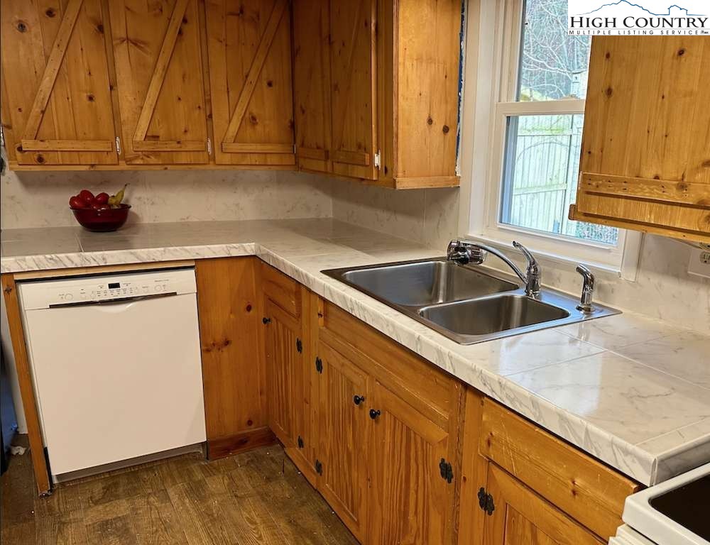 333 Mt Zion Road Deep Gap, NC 28618 - Photo 10 of 25 a kitchen with granite countertop a sink and cabinets