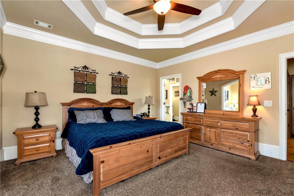 321 Chumbley Road Dawsonville, GA 30534 - Photo 23 of 65 a bed room with a bed and a chandelier