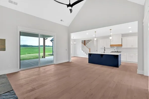 a large room with kitchen view and a window