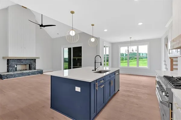 a kitchen with kitchen island a sink stove and a refrigerator