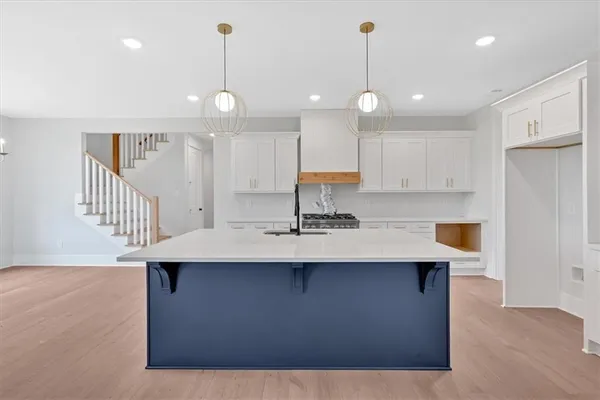 a kitchen with kitchen island a sink stainless steel appliances and cabinets