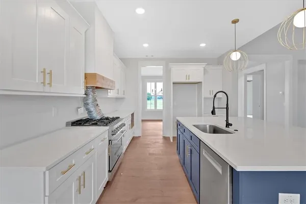 a kitchen with sink a stove and chairs