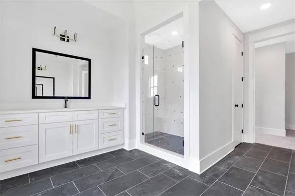 a bathroom with a shower sink and mirror