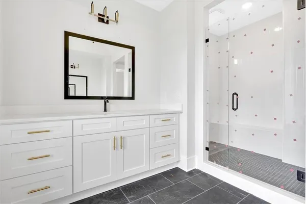 a bathroom with a sink vanity and mirror