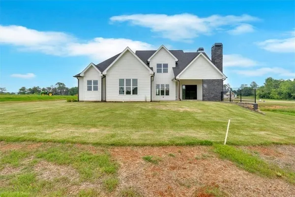 a front view of a house with a big yard