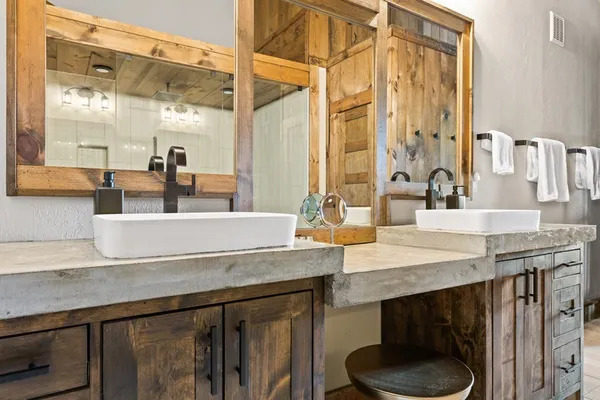 a dining table with granite countertop a sink and a mirror