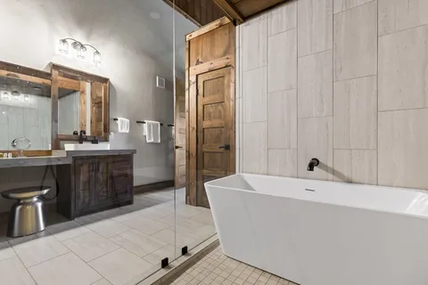 a spacious bathroom with a bathtub and a sink