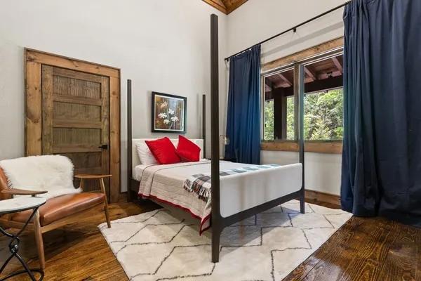 a bedroom with a bed and a window