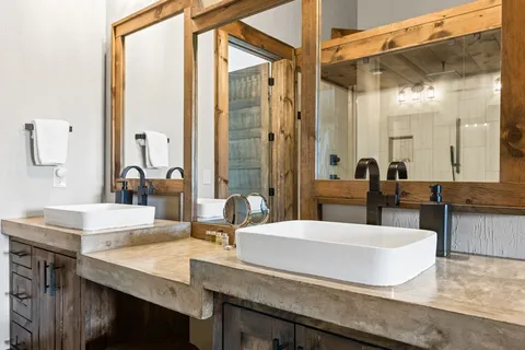 a bathroom with double vanity sinks and a mirror