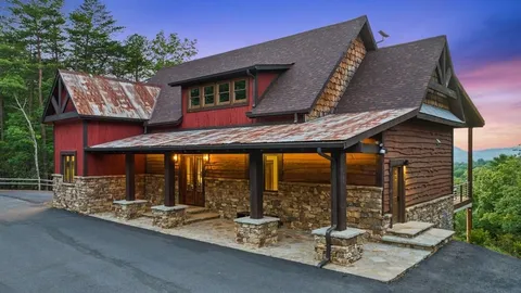 a view of a patio with table and chairs under an umbrella with a large tree