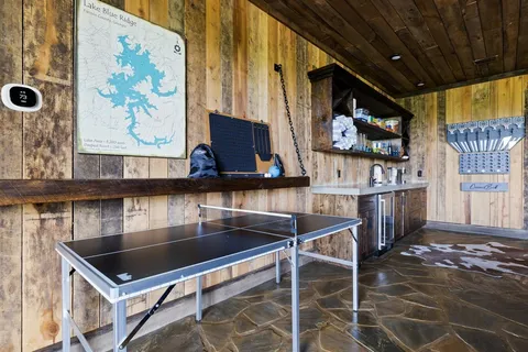 a room with table chairs and flat screen tv