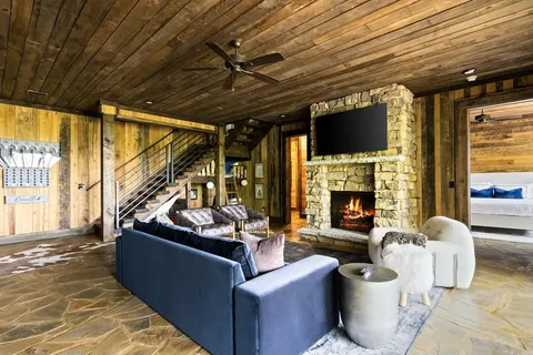 a living room with furniture fireplace and flat screen tv