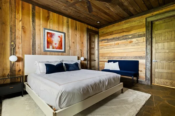 a bedroom with a bed and a couch