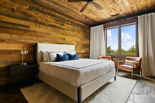 a bed room with a bed and a chair