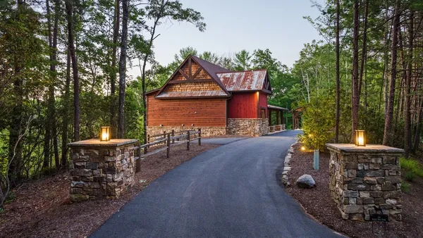 a view of a patio with table and chairs potted plants with wooden floor and fence