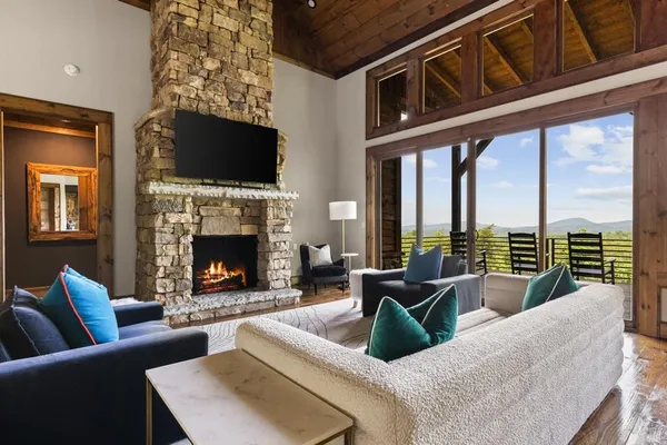 a living room with furniture fireplace and flat screen tv