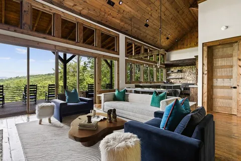a living room with furniture ceiling fan and a floor to ceiling window