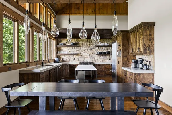 a large kitchen with a table and chairs