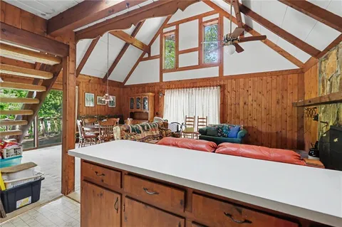 a view of living room with furniture and large windows