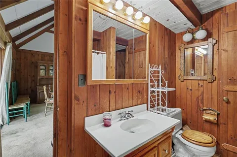 a kitchen with a refrigerator a stove top oven a sink and dishwasher with wooden floor